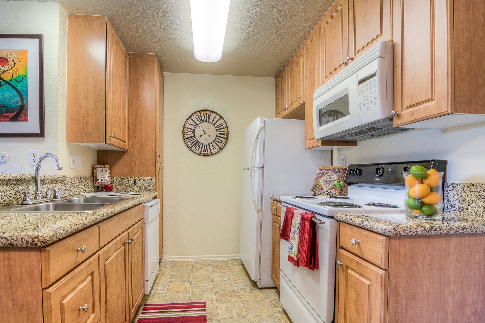 A kitchen with wooden cabinets and a white refrigerator.,A kitchen with wooden cabinets and a white refrigerator.